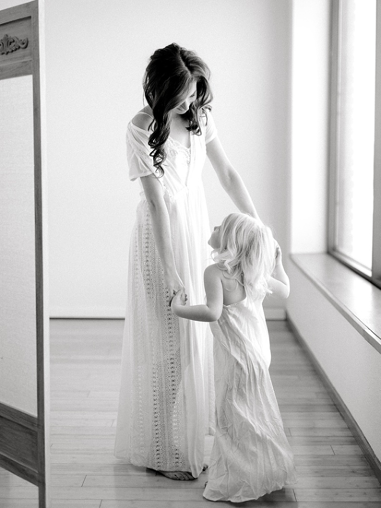 Natural light airy studio photos of two moms and their children in white dresses by fargo photographer two birds photography