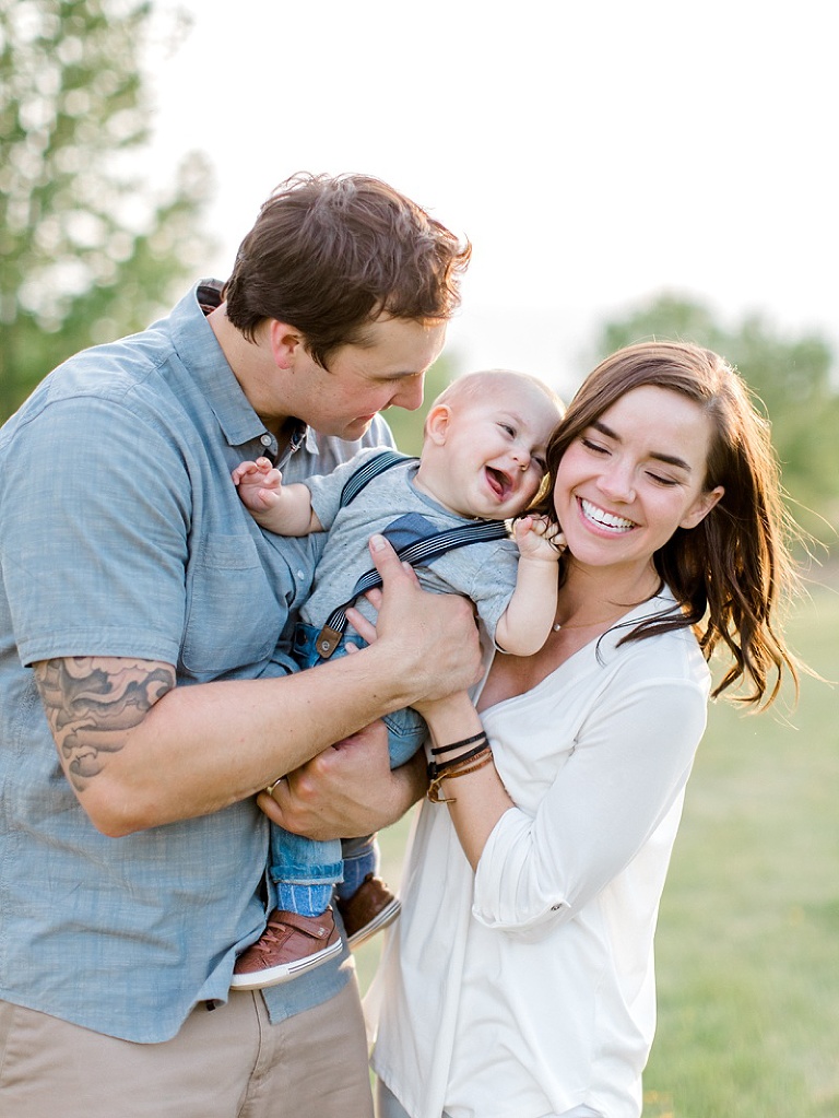 Spring family photos taken in fergus falls, minnesota of a mom, dad, and baby in an orchard, taken by two birds photography brittany walsh
